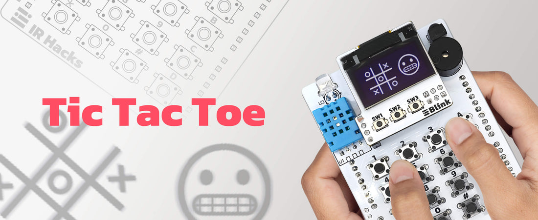 Hands playing Tic Tac Toe on the amomii IR Hacks board, its Blink OLED screen showing a noughts and crosses grid